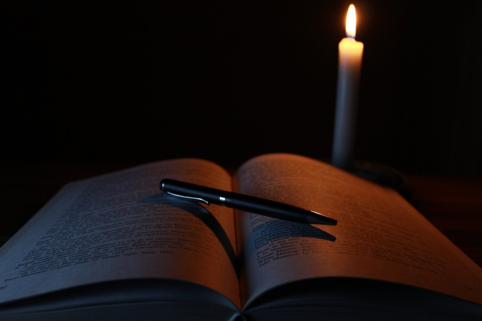 book and pen in candle light